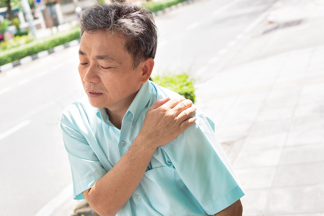 Senior man experiencing shoulder pain and discomfort
