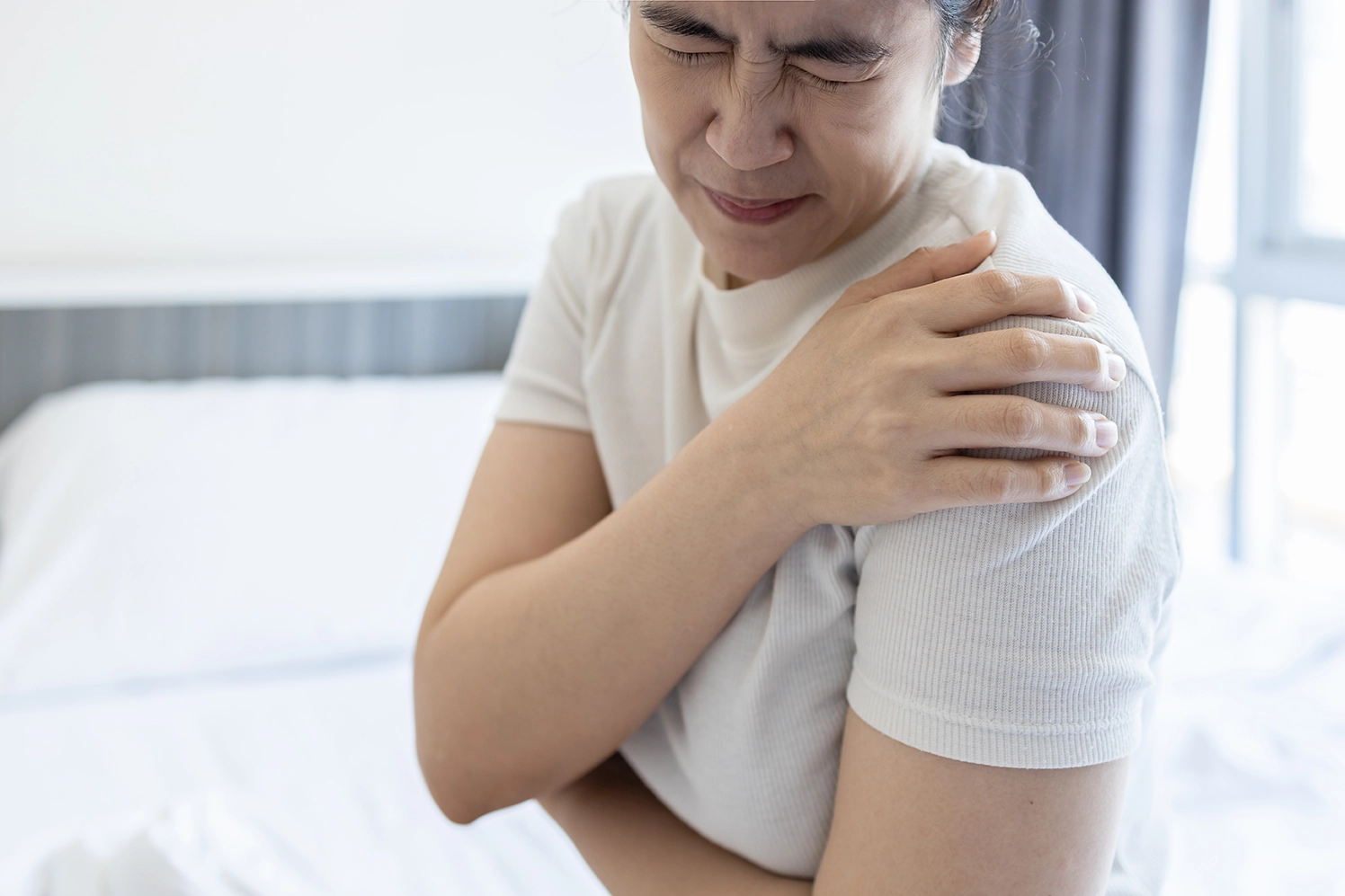 Senior man experiencing shoulder pain and discomfort