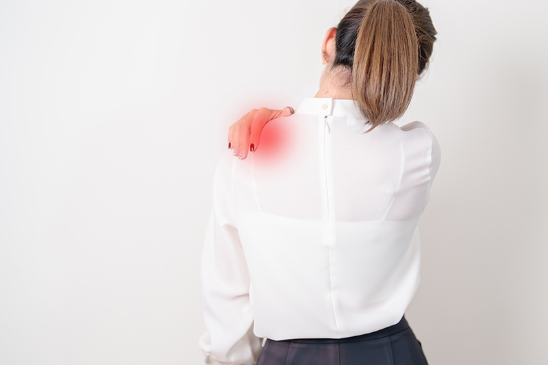 Woman experiencing shoulder pain and stiffness
